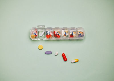 High angle view of pills on white background