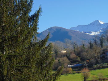 Scenic view of mountains against blue sky