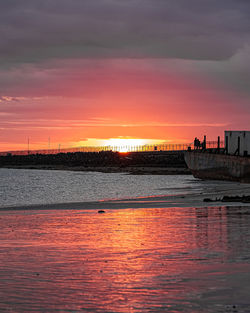 Scenic view of sea against romantic sky at sunset