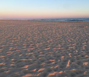 Scenic view of sea against clear sky during sunset