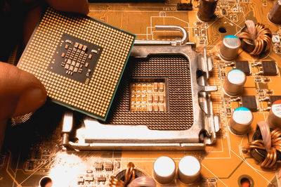 Cropped image of person working on motherboard