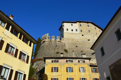 Low angle view of buildings against blue sky