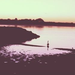 Scenic view of lake at sunset