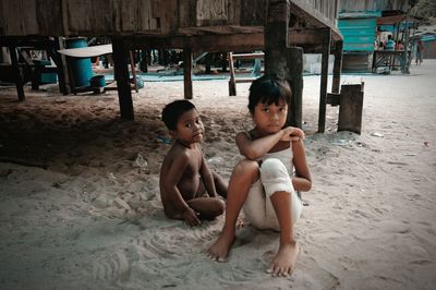 Portrait of boy sitting on sand