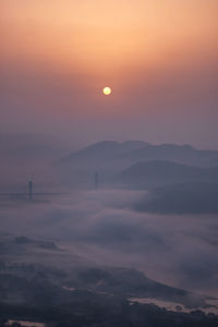 Scenic view of silhouette mountains against the romantic sky at sunset