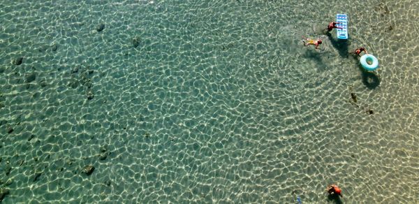 High angle view of people floating on sea