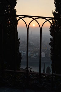 Scenic view of city against sky during sunset