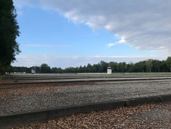 Railroad tracks by trees against sky