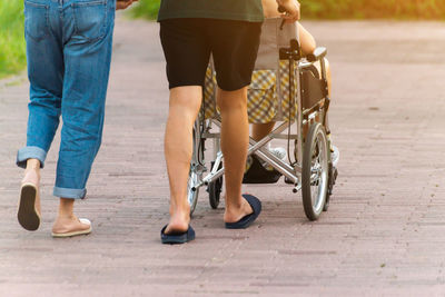 Low section of people walking on footpath