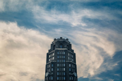 Low angle view of building against cloudy sky