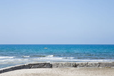 Scenic view of beach against clear sky