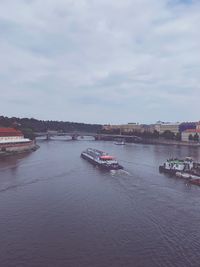 Scenic view of river against sky in city