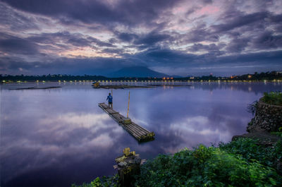 Scenic view of lake against dramatic sky