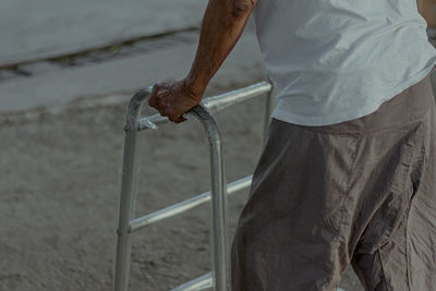 Midsection of man working at shore