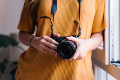 Midsection of woman photographing