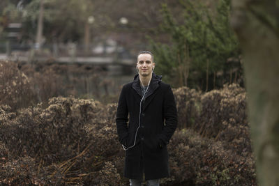 Portrait of young man standing on land