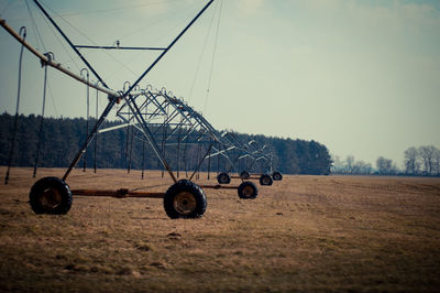 Wheeled objects on landscape against sky