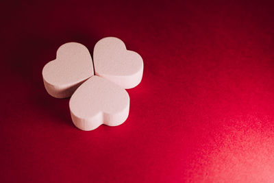 Close-up of heart shape on red table