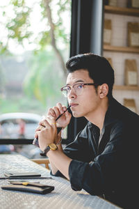 Young man drinking coffee at restaurant