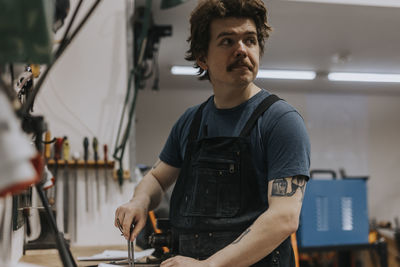 Male blacksmith working in workshop