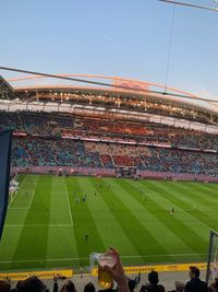 Group of people on soccer field against sky