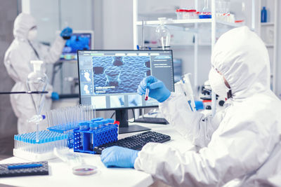 Midsection of scientist working in laboratory