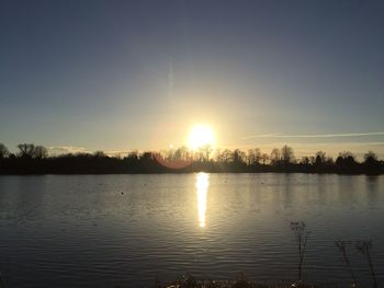 Scenic view of lake against sky during sunset