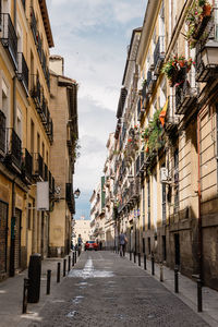 Street amidst buildings against sky