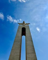 Low angle view of jesus statue against sky