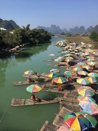 High angle view of wooden rafts with umbrellas on lake