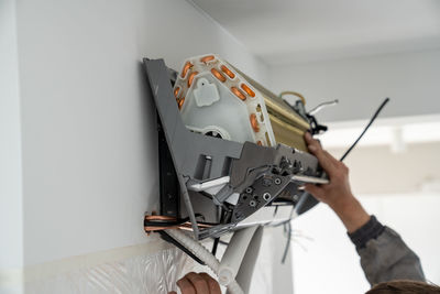 Cropped hand of man working at home