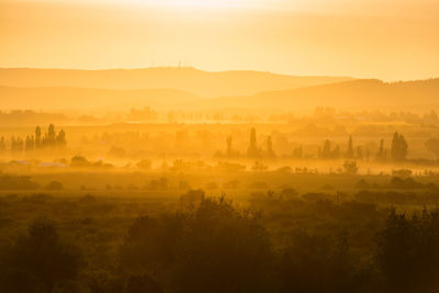 Scenic view of landscape against sky during sunset