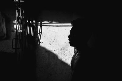 Portrait of young woman looking away against wall