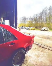 Close-up of red car against sky