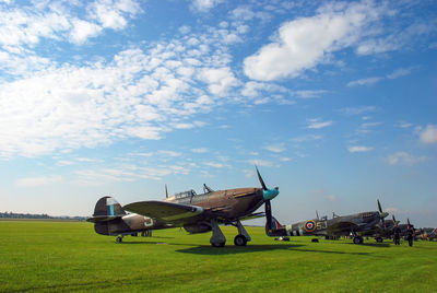 Raf fighter aircraft from the battle of britain era park at an airfield
