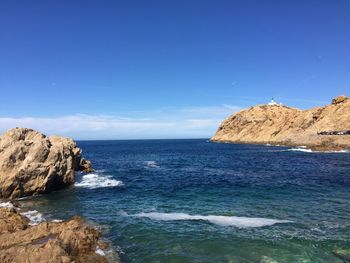 Scenic view of sea against clear blue sky