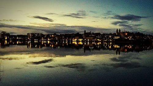 Reflection of illuminated building in water at night
