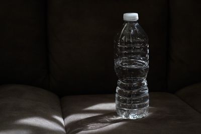 Close-up of glass bottle on table at home