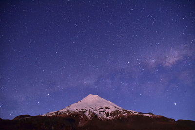 Scenic view of mountains against sky at night