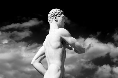 Low angle view of man statue against sky