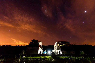 Built structure on field against sky at night