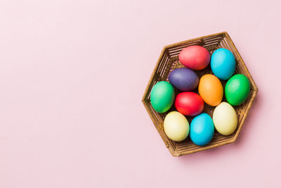 High angle view of easter eggs in carton against pink background