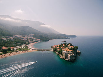 Scenic view of sea and mountains against sky