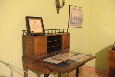 Electric lamp on table by wall at home