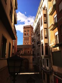 Low angle view of buildings in town against sky