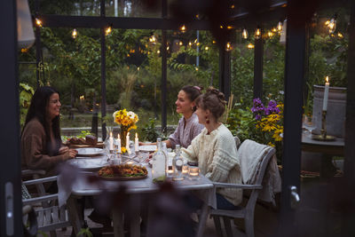 Midsection of woman sitting on table