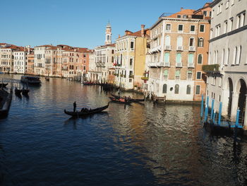 Buildings by canal in city