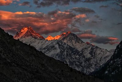 Scenic view of snowcapped mountains against sky during sunset