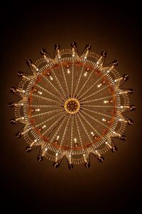 Low angle view of illuminated ferris wheel against sky at night