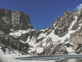 Scenic view of snowcapped mountains against clear sky